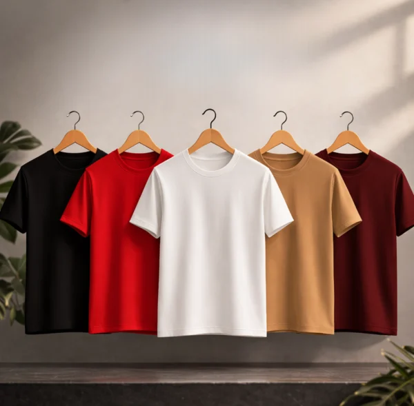 High-quality PLAIN crewneck cotton t-shirt hanging on a wooden hanger against a neutral wall with pink roses.